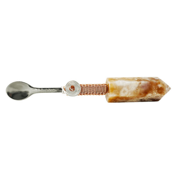 A crystal spoon with copper wire wrapping.