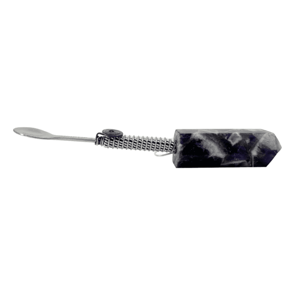 Silver spoon attached to amethyst crystal.