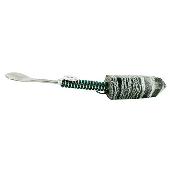 Silver spoon with black and white stone handle.