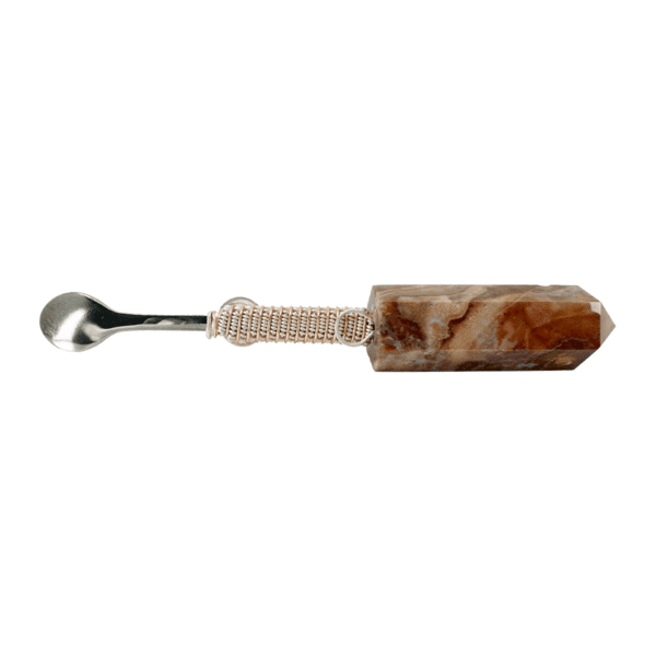 A spoon with a marble handle on it.