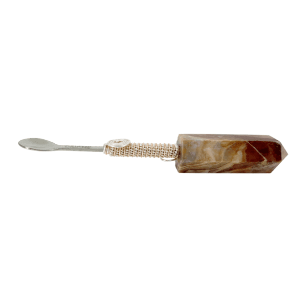 A brown and white toothbrush with a metal handle.