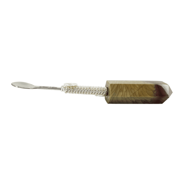 Silver spoon wrapped with stone handle.