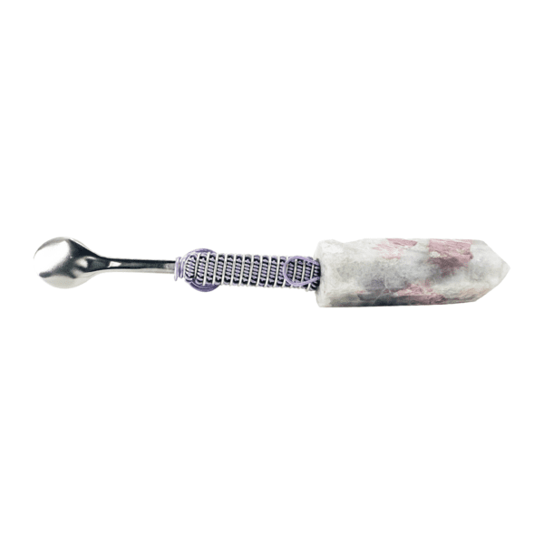 A wrench with a purple handle and a white stone.