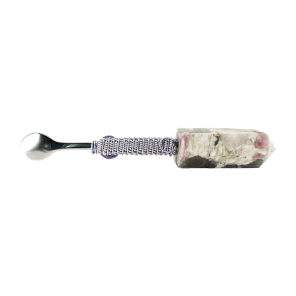 A spoon with a white and purple handle.