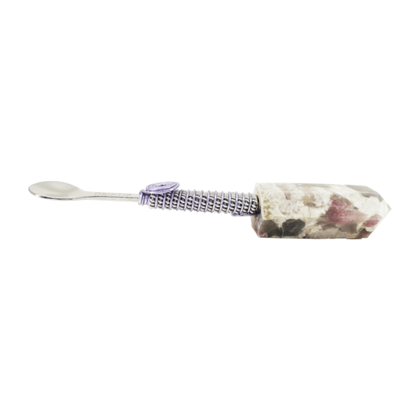 A purple and white floral print toothbrush holder.