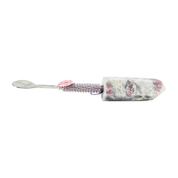 A toothbrush with a pink and white pattern on it.