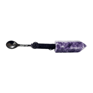 A purple stone with a black handle and a spoon.