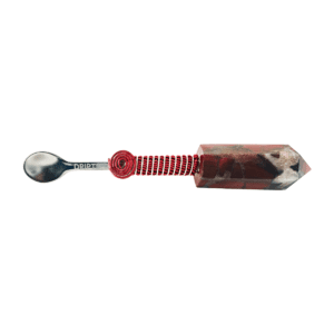 A spoon with a red handle and a red string.