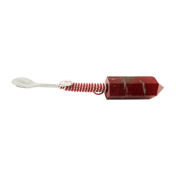 A red and white toothbrush with a wooden handle.