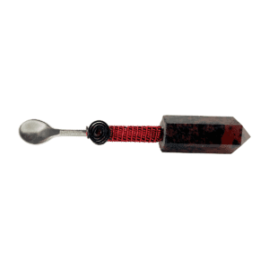 A spoon with a red string and black handle.