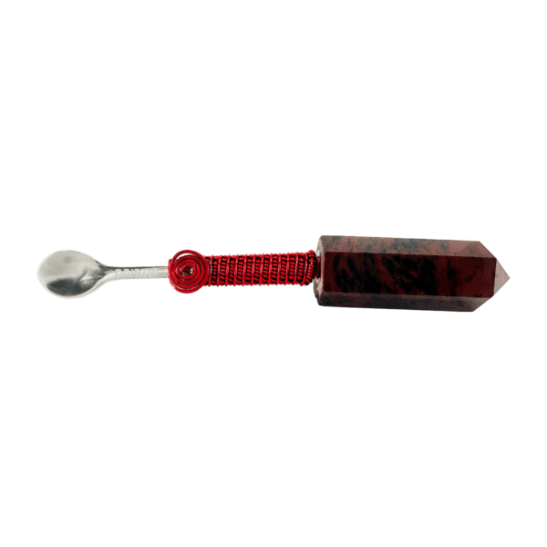 A spoon with a wooden handle and red string.