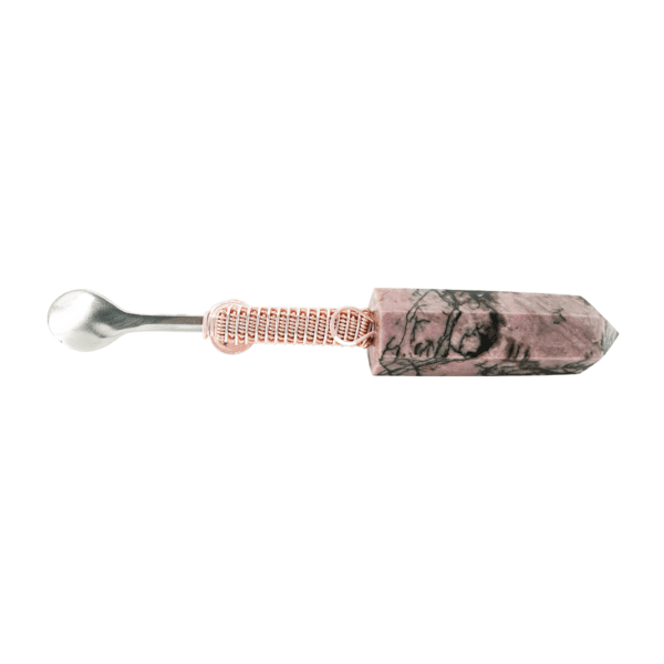 A spoon with a pink and white floral design.