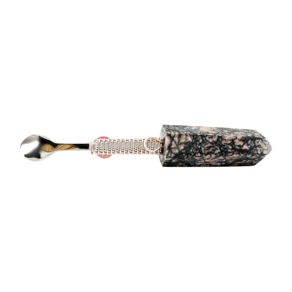 A black and white spoon with pink flowers on it