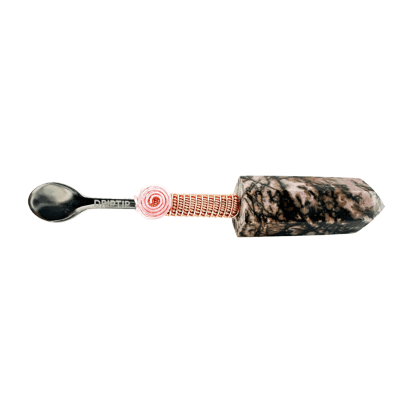 A spoon with a pink flower on it.