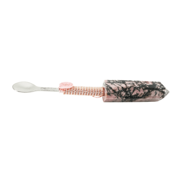 A toothbrush with pink and black flowers on it.