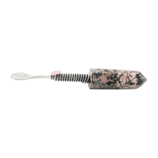 A pink and black toothbrush with a white handle.