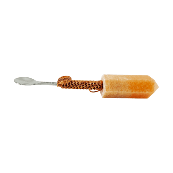 A yellow crystal spoon with copper wire.