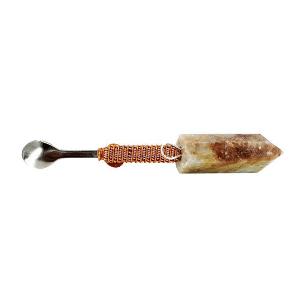 Stone and metal tea spoon utensil.