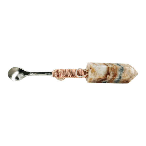 Stone spoon with metal handle and wire wrap.