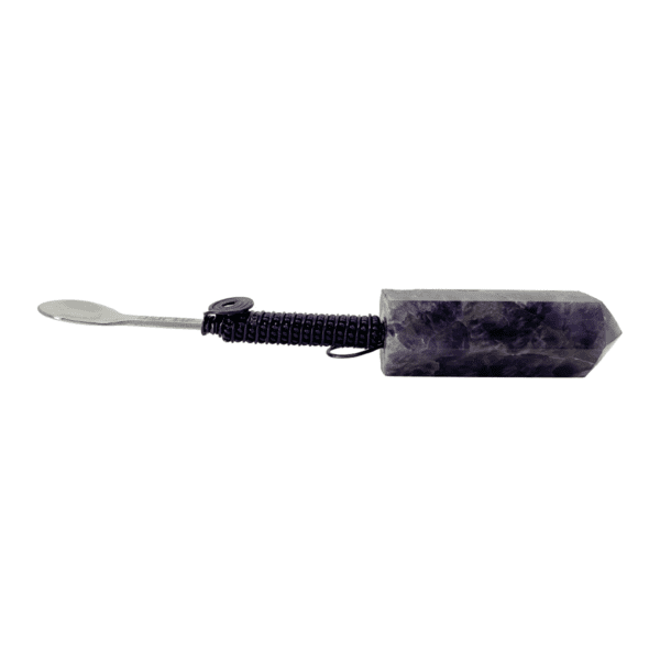 Amethyst crystal with a metal spoon.