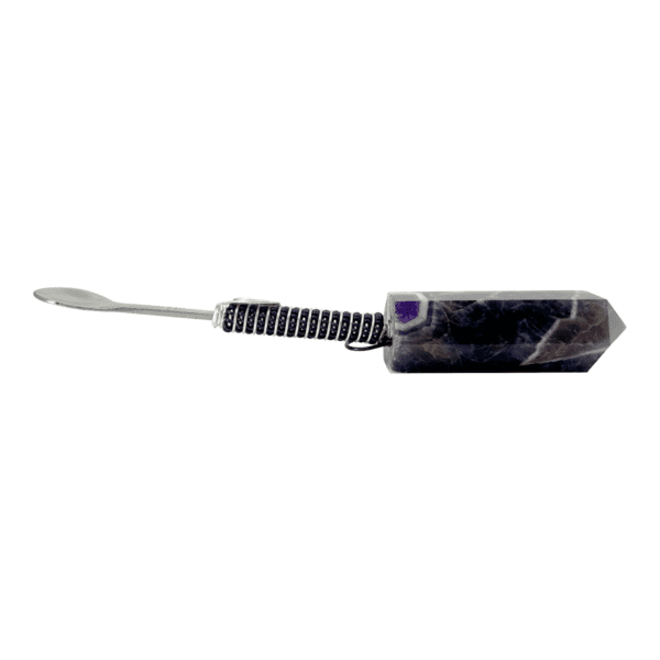 Amethyst crystal with a metal scoop.