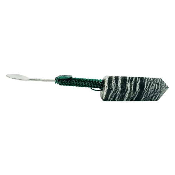 Green wrapped stone wand with a spoon.