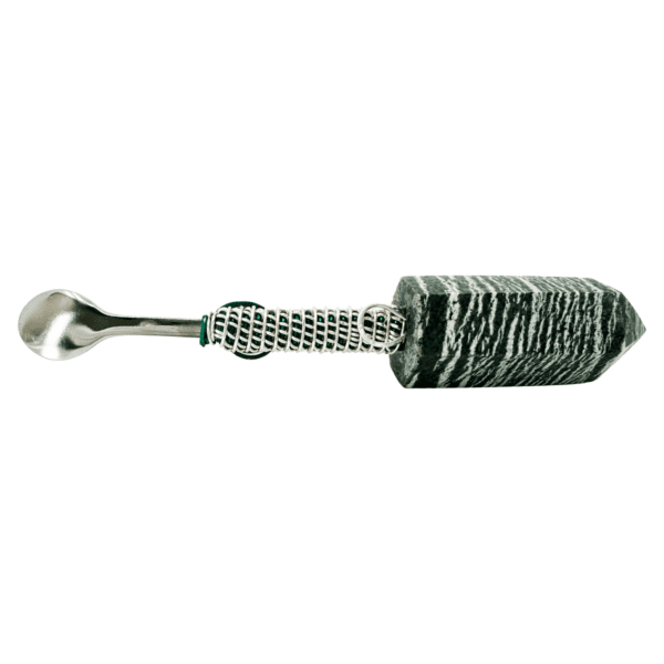 Silver spoon attached to a black and white stone.