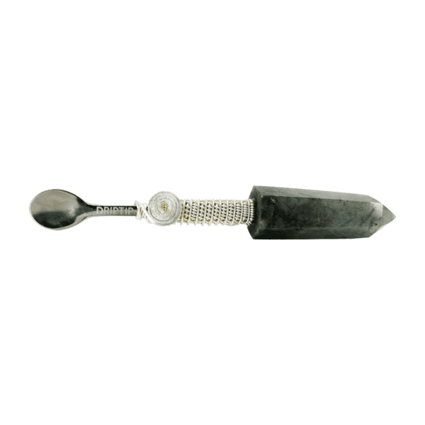 Silver spoon attached to black crystal.