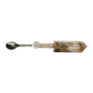 A spoon with a brown and white marble handle.