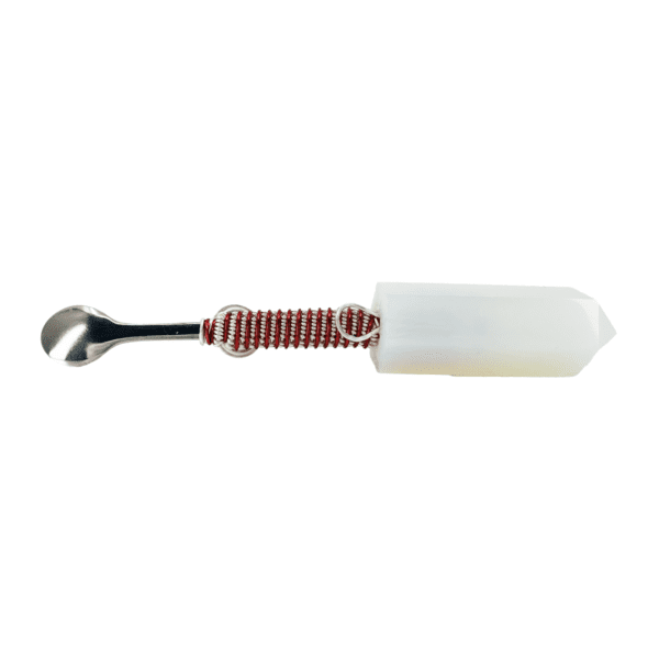 A white and red plastic handle with a metal wrench.