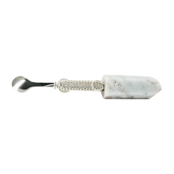 A white and silver spoon with a marble handle.