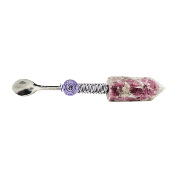 A spoon with flowers on it and purple handle.