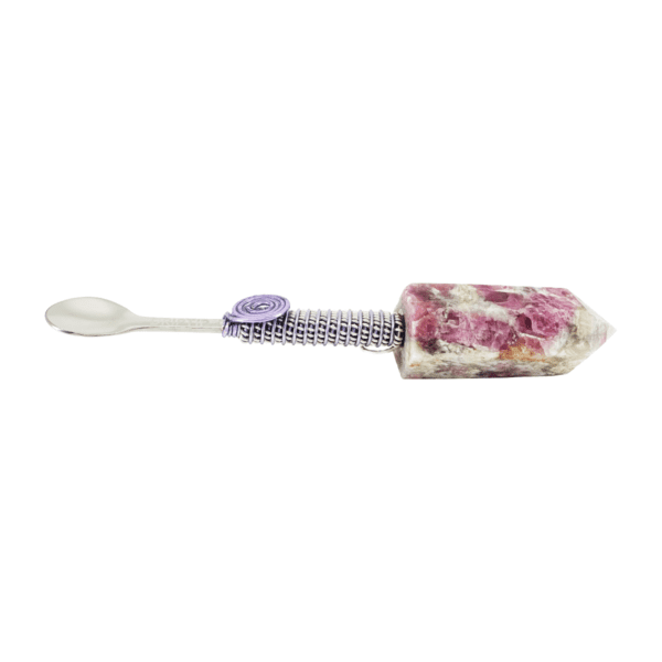 A toothbrush with flowers on it and purple button.