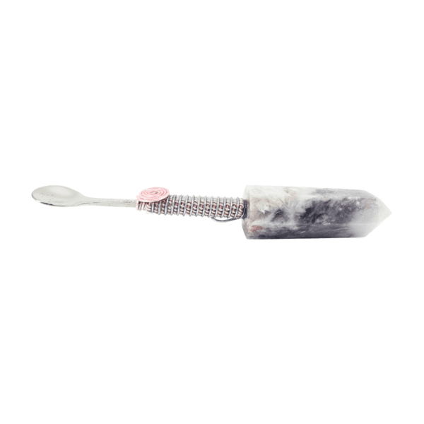 A toothbrush with pink and white beads on it.