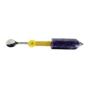 A purple and yellow pen with a metal spoon.