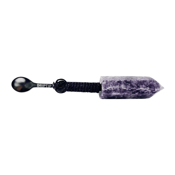 A spoon with purple stone handle and black plastic handle.