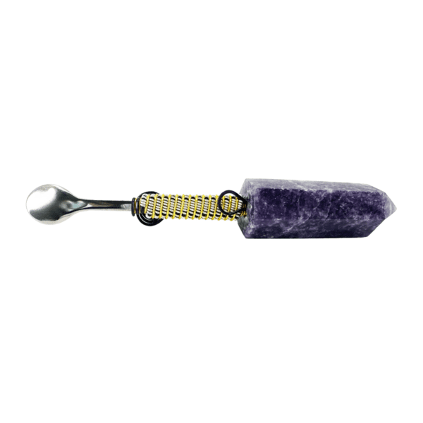 A purple stone with a yellow metal handle.