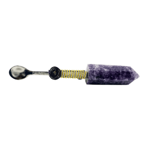 A purple stone with a black handle and yellow thread.