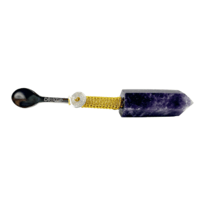 A purple stone with a yellow handle and a black stick