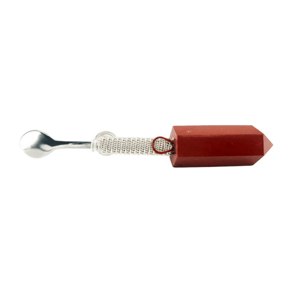 A red object with a metal handle and a white string.