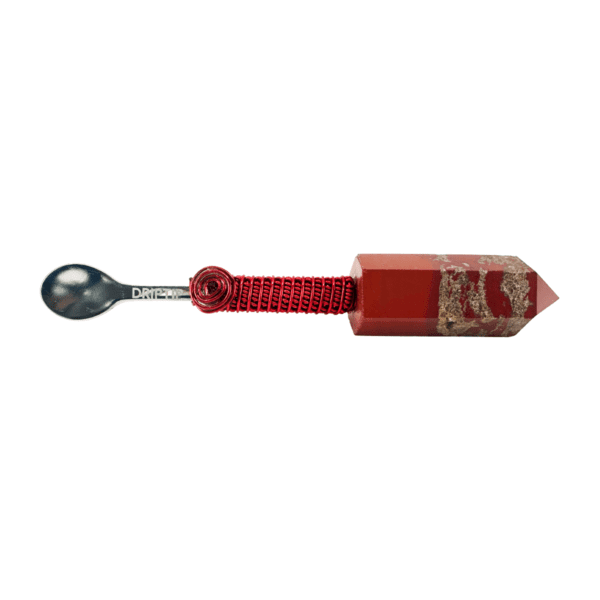 A spoon is attached to the end of a red cord.