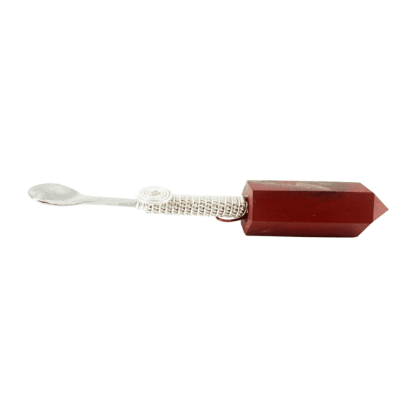 A red toothbrush with white handle and a brush on top of it.