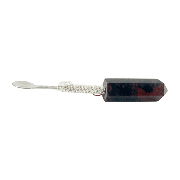 A red and black toothbrush with a white string.