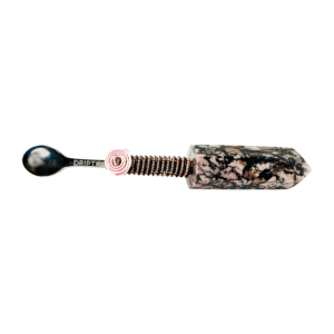 A spoon with a pink handle and some flowers