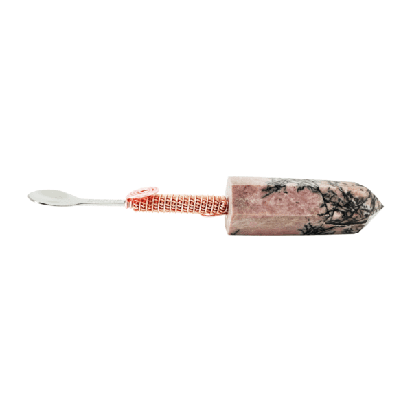 A toothbrush with a pink and black design on it.