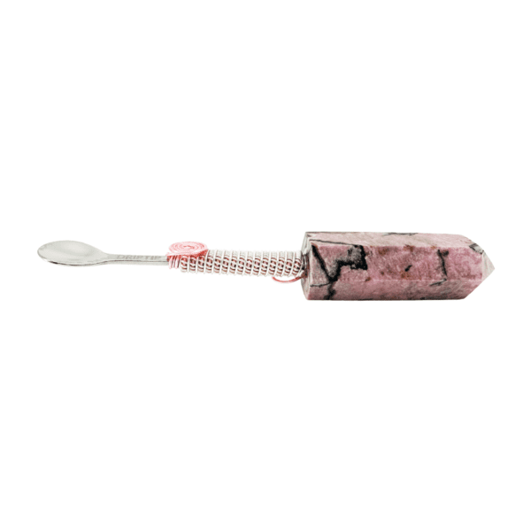 A pink toothbrush with a white handle and a black face.