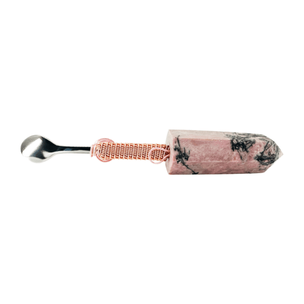 A pink and black toothbrush with a metal handle.