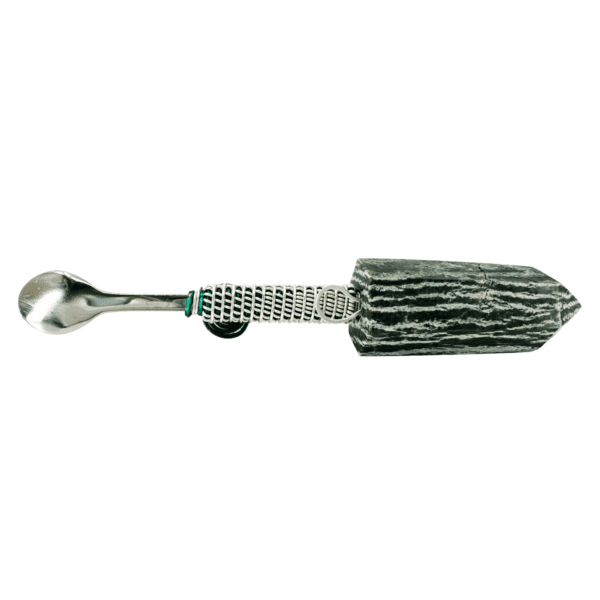 Silver spoon attached to black crystal.