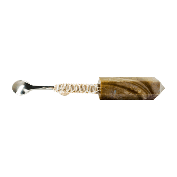 A spoon with a brown and white handle.