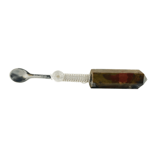 Silver spoon with brown crystal handle.